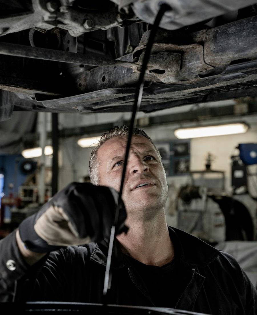 Technician working under a lifted vehicle